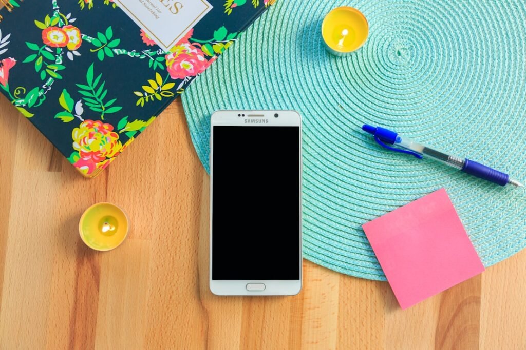 looking for cheap phone plans? Mobile phone sitting on a colourful desk